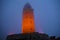 Illuminated lighthouse in evening