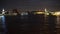 Illuminated night landmarks and trip boats on skyline