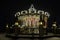 Illuminated old-fashioned carousel in a shopping and entertainment center in Moscow, night view.