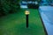 Illuminated outdoor light in apartment garden at twilight, evening.