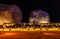 Illuminated outdoor lounge in front of elephant rock erosion monolith standing in the night desert, Al Ula, Saudi Arabia