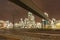 Illuminated petrochemical production plant with train tracks in front, Antwerp, Belgium