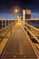 Illuminated pier on large steel mooring posts