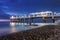 Illuminated pier at night with the dark sky background