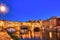 Illuminated Ponte Vecchio Bridge with Reflection in Arno River at Dusk, Florence