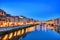 Illuminated Ponte Vecchio Bridge with Reflection in Arno River at Dusk, Florence
