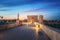 Illuminated Roman Bridge of Cordoba at sunrise with San Rafael Statue and Calahorra Tower - Cordoba, Andalusia, Spain