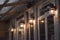 Illuminated rustic lanterns by the windows on the porch