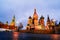 Illuminated Saint Basil Cathedral on Red Square at night with Kremlin wall and Tower