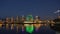 Illuminated Science World museum and Vancouver skyline reflected in False Creek at night