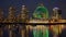 Illuminated Science World museum and Vancouver skyline reflected in False Creek at night