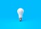 Illuminated Serenity: Light Bulb on a Blue Background