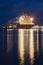 Illuminated ship in a port at night