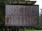 An illuminated sign warning of Social Distancing