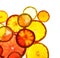 Illuminated slices of citrus fruits on white background