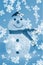 Illuminated snowman with white snowflakes on blue background