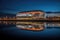 illuminated sports stadium reflecting on water