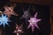 Illuminated stars in coloured colours on the Christmas market