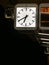 Illuminated station clock, in the evening on the platform of a subway station