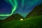 Illuminated tent in Norway with the northern lights overhead