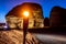 Illuminated by torch sandstone elephant rock erosion monolith standing in the night desert, Al Ula, Saudi Arabia