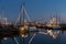 Illuminated traditional wooden fishing ships at night in Dutch harbor