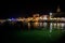 Illuminated Village Fazana In Croatia In The Night With Old Church And Boats In Harbor