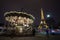 Illuminated vintage carousel and Eiffel Tower at night, Paris