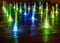 Illuminated waterspout fountain at night