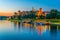 Illuminated Wawel castle in the polish city Krakow/Cracow reflected on the Vistula/Wisla river during night....IMAGE