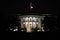 Illuminated White House building in Washington at night.