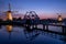 Illuminated windmills, a bridge and a canal at sunset