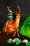 Illuminated young deer lantern standing in a lush, green forest