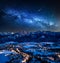 Illuminated Zakopane city in winter and milky way at night