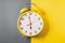 Illuminating color Retro style alarm clock on ultimate gray and yellow background