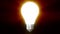 Illuminating Creativity, 4k Light bulb moving towards camera and flashing over black background, problem solving ideas concept