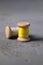 Illuminating Yellow and Ultimate grey colored threads wooden bobbins