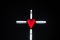 Illumination of a cross with red heart