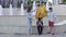 Illusionist showing trick with tied hands and rope for passersby at the street