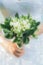 Illustration of beautiful wedding bouquet of white freesia flowers in bride\'s hand.