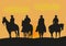 Illustration of cowboys riding at sunset