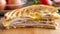 An illustration of a cut cheese and ham toasted panini melt with grill mark