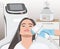 Illustration. Epilation hair removal procedure on a woman’s face. Beautician doing laser rejuvenation in a beauty salon