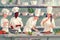 Illustration of four diverse chefs cooking in a professional kitchen setting