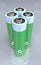 Illustration of four standing green and blue batteries with recycle symbol