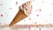 An illustration of an ice cream cone with hundreds and thousands sprinkles falling on it against a white background.