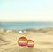 Illustration of lesbian flag and golden wedding rings on sandy beach