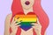 Illustration of a sexy transgender person holding a rainbow flag heart.