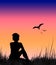 Illustration, silhouette of woman sitting in grass, birds, sunset sky