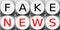 Illustration of two rows of dice with Fake News sign